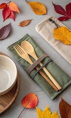 Reusable bamboo cutlery set in a cloth pouch with autumn leaves