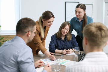 Business coach working with group of people in office
