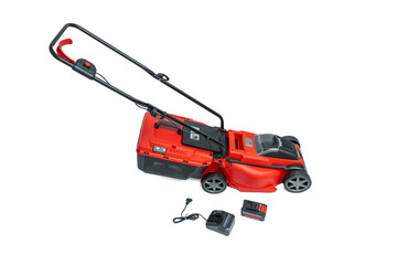 Lawn mower with battery and charger. Cordless lawn mower in a red design with grass catcher, charger, and battery isolated on a white background. Perfect for cordless mowing.