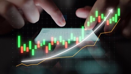 Close-up of hands using a smartphone to explore stock market trends, featuring green and red bars on a digital display illustrating growth and financial data. Copula
