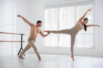Couple of professional dancers training in studio