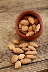 Close up of fresh almonds spilled out of clay pot