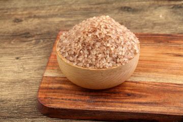Brown rice in wooden bowl