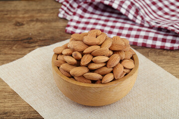 Fresh almonds in wooden bowl 