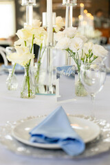 Festive table setting in the restaurant with flowers. Wedding decor