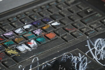Close-up of a computer keyboard, covered in various colors and markings