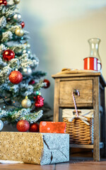 Christmas gifts in close-up in front of the tree