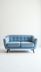 A light blue, mid-century modern sofa with tufted cushions and angled wooden legs sits against a plain white background, conveying elegance and simplicity.