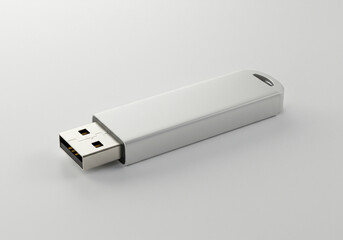 Blank USB flash drive on white surface, close-up shot 