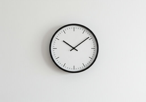 Blank wall clock with minimalist design, white wall background 