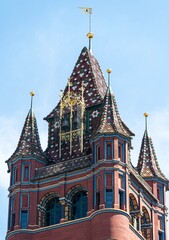 The richly decorated red turret of the town hall in Basel, Switzerland