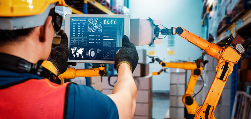 Smart robot arm systems for innovative warehouse and factory digital technology . Automation manufacturing robot controlled by industry engineering using IOT software connected to internet network .