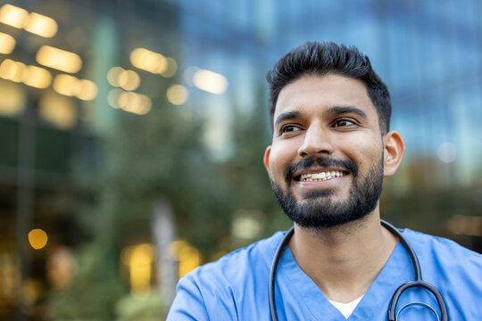 Confident healthcare professional smiling with stethoscope outdoors by modern building