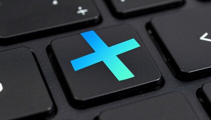 Fototapeta premium Close-up view of a computer keyboard key with a vibrant blue-and-green plus sign graphic, exhibiting a modern and technological design aesthetic.