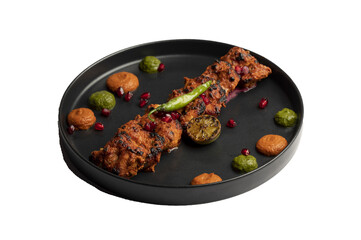 Classic Chicken Tikka — Tender chicken marinated in yogurt and aromatic spices, skewered and cooked in a clay oven, garnished with anardana and served with green and red chutney. PNG isolated.