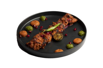 Classic Chicken Tikka — Tender chicken marinated in yogurt and aromatic spices, skewered and cooked in a clay oven, garnished with anardana and served with green and red chutney. PNG isolated.