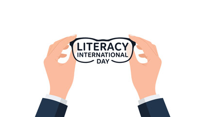Hands holding eyeglasses with "Literacy International Day" text, symbolizing education and vision.