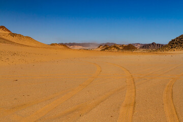 The landscape of the Sahara. A rocky desert, sandy dunes, and bizarre rocky mountains. El Berdj Canyon, Tassili n'Ajjer National Park, Algeria.