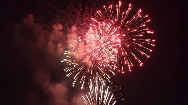 Mexican Fireworks Display - Vibrant fireworks explode in the night sky, showcasing bursts of red, white, and green &ndash; the colors of the Mexican flag.