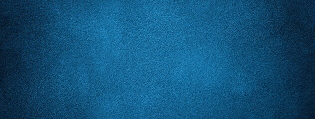 Dark blue background of suede fabric, macro. Velvet texture of navy textile. Felt soft denim backdrop with vignette