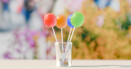 colorful lollipops on a glass outdoors