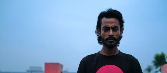 Angry face asian adult male with blue sky background