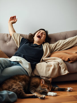 Yawning lazy woman stretching on sofa in unwillingness and inability to work, overwhelmed by laziness and apathy. Cat sleeping near owner on floor, boredom, melancholy and emotional detachment