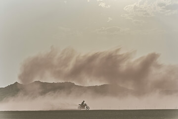 Motorcyclist rides through desert dust storm