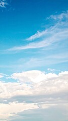 A vibrant blue sky with fluffy white clouds