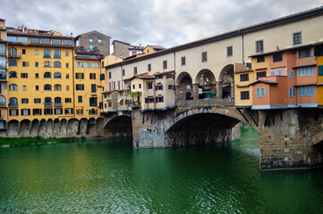 View of the historic Ponte Vecchio bridge over the Arno river in the old part of Florence, Tuscany, Italy.