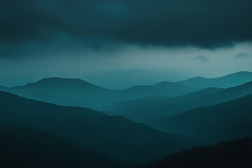 Moody mountain range landscape with dramatic, atmospheric blue tones
