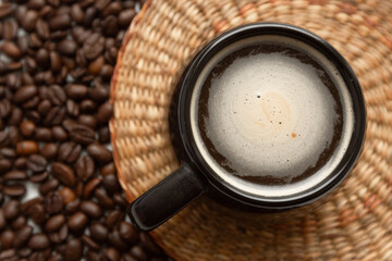 Cup of coffee with coffee beans in the background. World Coffee Day, americano and espresso background