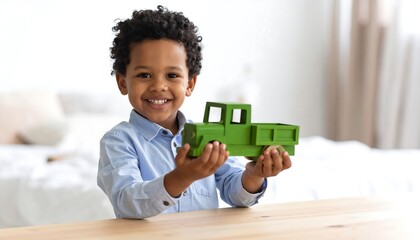 Happy boy plays with toy truck.