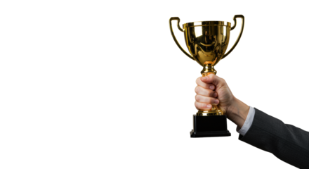 Professional hand with manicured nails in neutral top holding aloft a gleaming golden championship trophy against a softly lit, seamless neutral studio background. Concept of ultimate success and