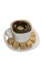 A cup of black coffee and a sugar dropping into it on the surface causing a splash, served in a white cup on a saucer filled with many brown sugar cubes isolated on a transparent background.