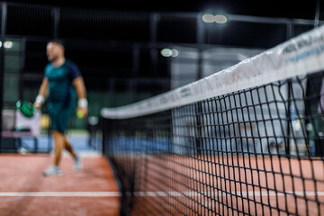 Padel players enjoying a match at night on a well-lit court