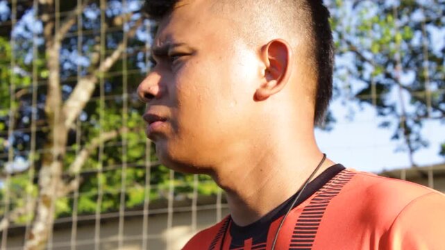 Portrait of a young Latino professional coach watching a soccer game on a synthetic field in Neiva, Huila, Colombia. Healthy lifestyle concept