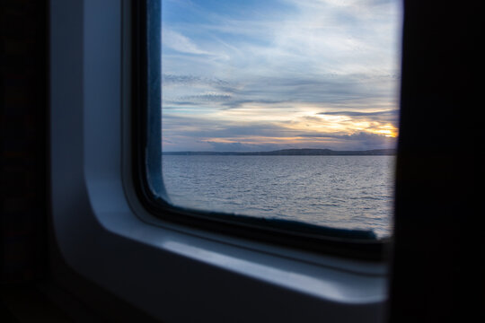 View from the ferry window of the sea and hills