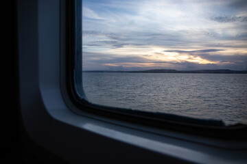 View from the ferry window of the sea and hills