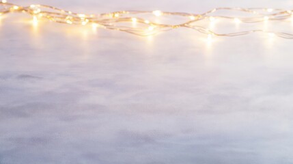 Warm, glowing string lights draped over a cool, textured surface.