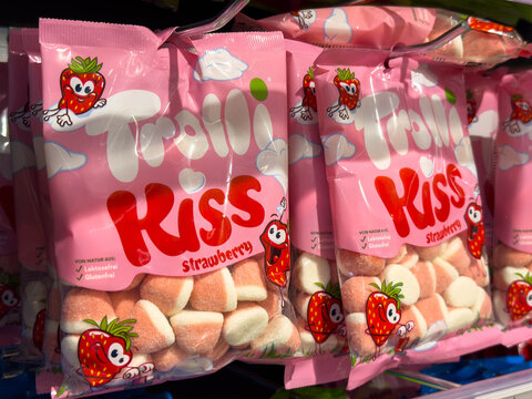Villach, Austria - August 21, 2025: Colorful packaging of Trolli Kiss strawberry gummy candies displayed on store shelf, showcasing vibrant design and playful branding for sweet treat lovers