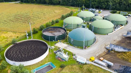 Biogas plant and farm in green fields. Renewable energy from biomass. Modern agriculture in Czech Republic and European Union.   © Kletr