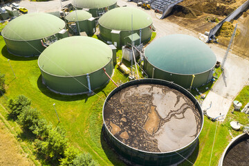 Biogas plant and farm in green fields. Renewable energy from biomass. Modern agriculture in Czech Republic and European Union.	

