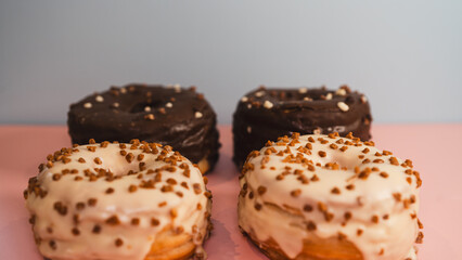 Extreme close-up of a chocolate donut and a white chocolate donut with salted caramel glaze, highlighting texture and decadent details. Perfect for food blogs, dessert menus, and social media content
