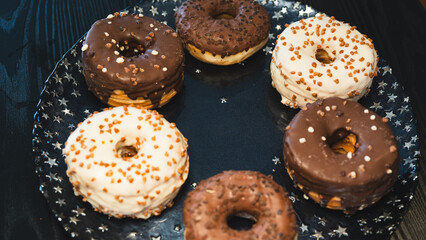 A vibrant selection of assorted donuts with various toppings and glazes, perfect for bakeries, cafés, or dessert promotions. Professional food photography with bright lighting