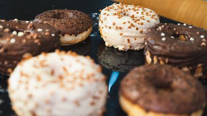 A vibrant selection of assorted donuts with various toppings and glazes, perfect for bakeries, cafés, or dessert promotions. Professional food photography with bright lighting