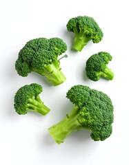 Fresh broccoli florets against white