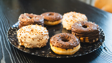 A vibrant selection of assorted donuts with various toppings and glazes, perfect for bakeries, cafés, or dessert promotions. Professional food photography with bright lighting