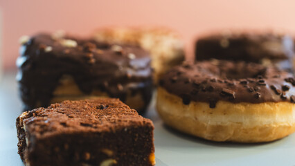 Decadent, fudgy chocolate brownies presented on a vibrant pink and blue background. Ideal for bakery advertising, dessert blogs, or social media content. Professional food photography with bold colors