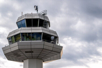 Modern Airport Control Tower with Geometric Structure and Cloudy Sky on a Rainy Day
